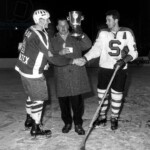6206325 Spengler Cup, 1964 Award Ceremony (b/w photo); (add.info.: Award ceremony without winner. The players of the EV Fuessen did not see a chance to win the Spengler Cup after their games and left early. But since the Swedes of MoDo Alfredsham sensationally beat the favored Czech or Sparta Prague 8:4 in the last game of the tournament, the EV Fuessen surprisingly won the tournament. Sparta Captain Ludek Bukao, right, congratulates the captain of Alfredshem Nils Johannsson, left to victory, while a left behind official of EV Fuessen, center, receives the trophy at the award ceremony, taken on December 30, 1964.); Photopress Archiv/Keystone.