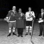 6206355 Spengler Cup, 1964 Award Ceremony (b/w photo); (add.info.: Award ceremony without winner. The players of the EV Fuessen did not see a chance to win the Spengler Cup after their games and left early. But since the Swedes of MoDo Alfredsham sensationally beat the favored Czech or Sparta Prague 8:4 in the last game of the tournament, the EV Fuessen surprisingly won the tournament. A functionary of EV Fuessen, left behind in the middle, accepts the trophy at the award ceremony after the last game, flanked by Sparta Captain Ludek Bukao, right, and the captain of Alfredshem Nils Johannsson, left, taken on December 30, 1964.); Photopress Archiv/Keystone.